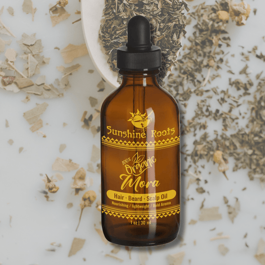 Bottle of Sunshine Roots Mora hair, beard, and scalp oil with a dropper on a textured background.